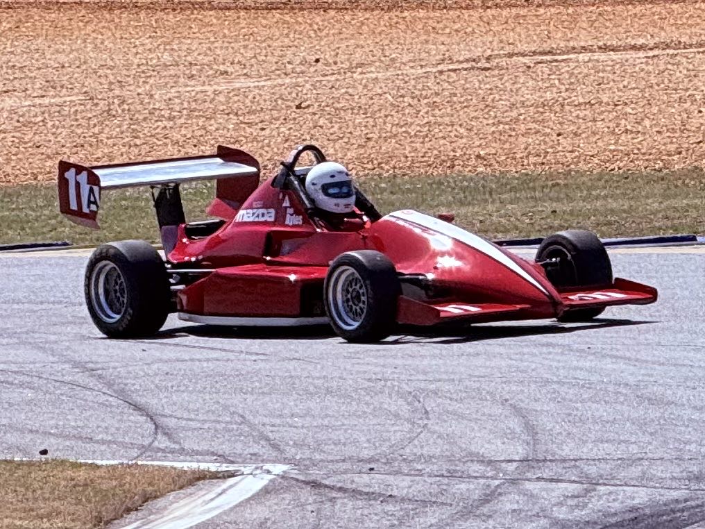 A small Mazda-badged open-wheel race car