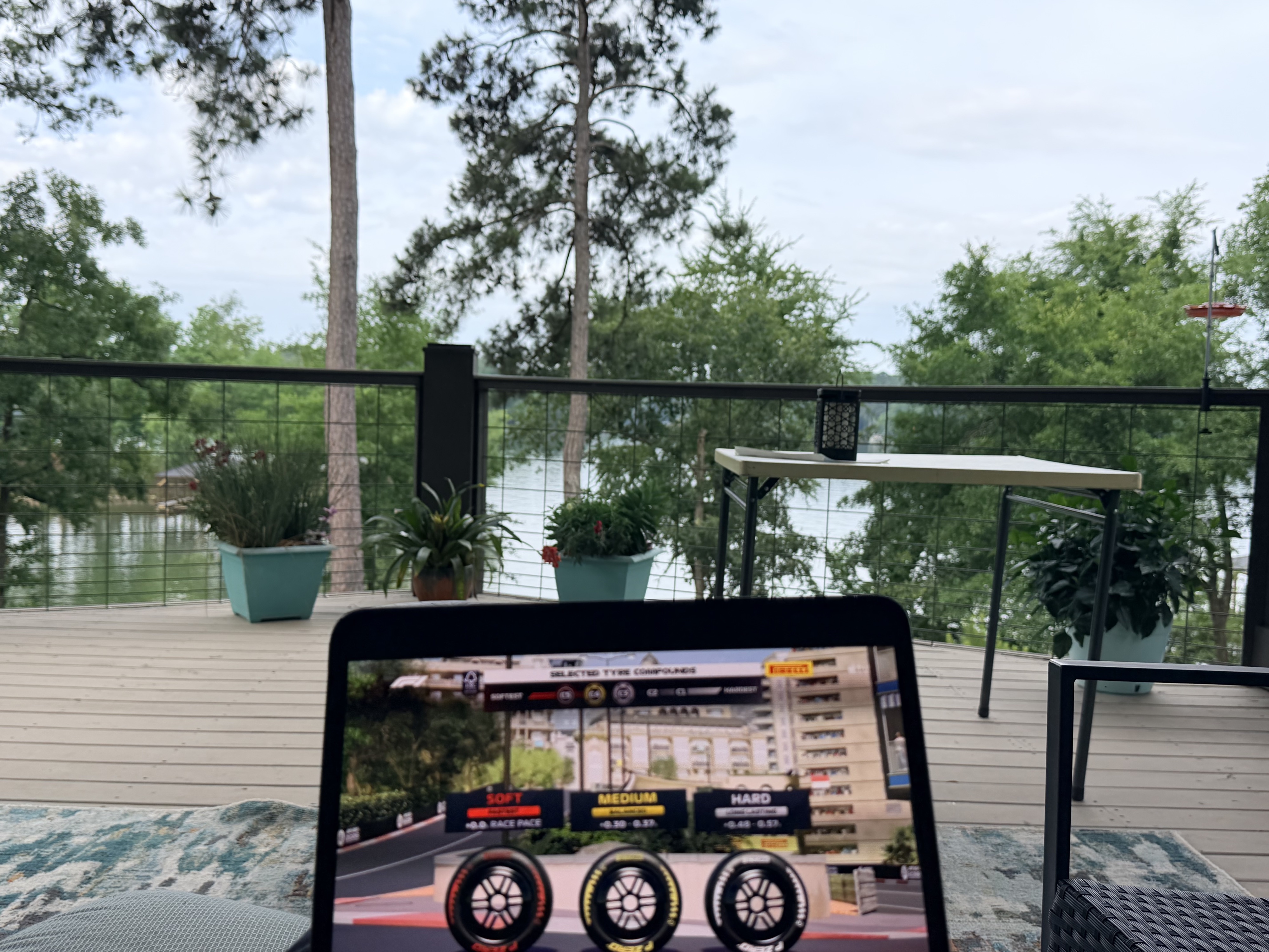 An iPad showing the Formula 1 broadcast on a lakeside deck